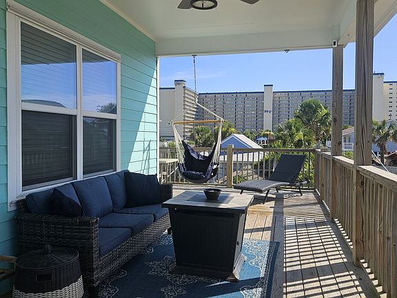 Large deck offers covered space with outdoor furniture