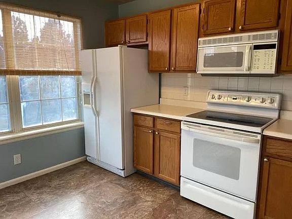 Sunny kitchen with tidy appliances and plenty of storage.