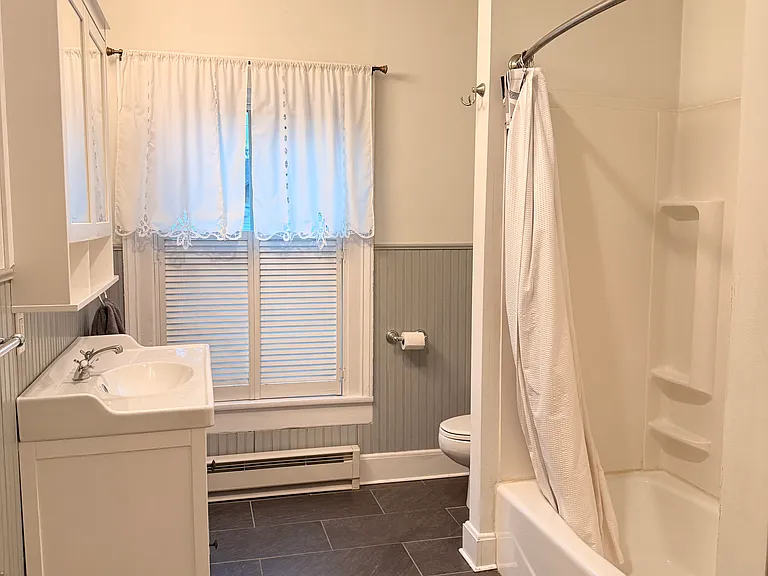 Full bathroom with new tile flooring.