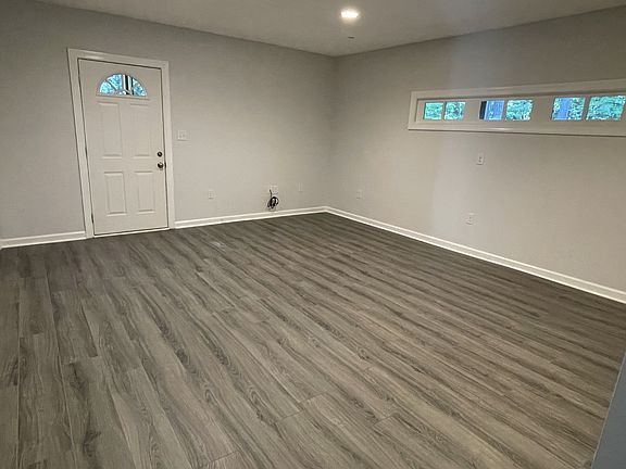 A spacious living room! This interior view shows the front door to the apartment along with the large open living room area.