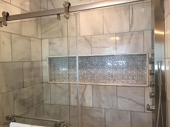 Master bath walk-in shower with marble tile and heated floor