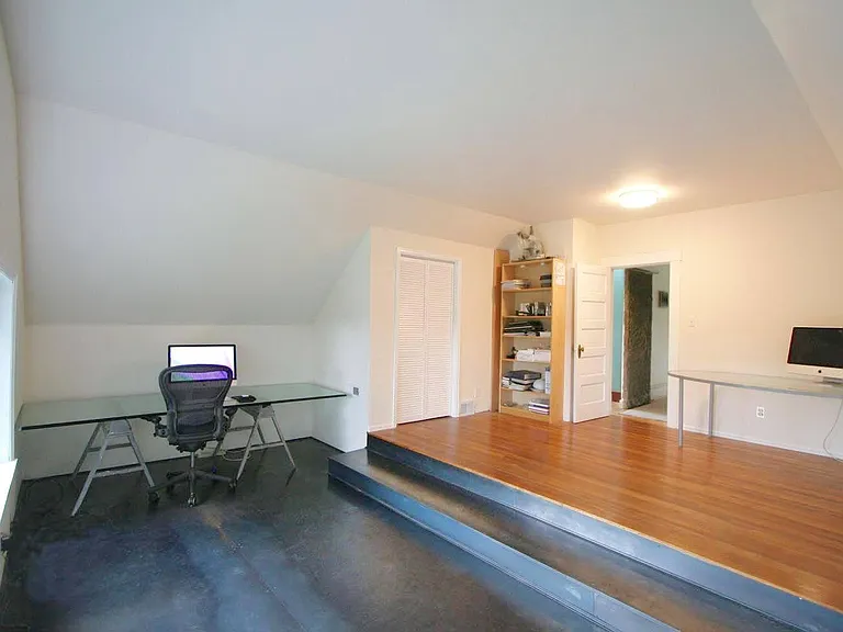 Upstairs: Very large Primary Bedroom (set up as an office). Giant windows facing West overlooking secluded garden.