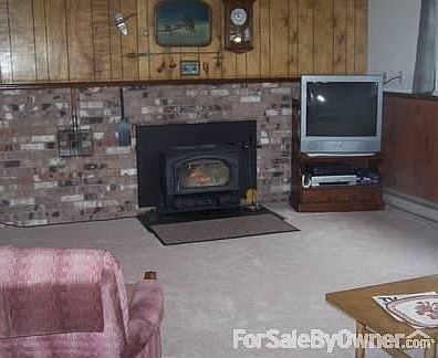 Family Room Lower Level W/ Fire Place : Lower level newely carpeted. Woodburning fireplace. Heats th