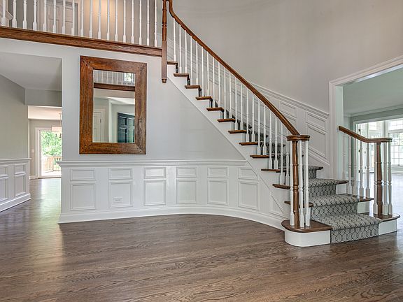 Grand and spacious foyer with custom wainscoting and gorgeous refinished hardwood floors.