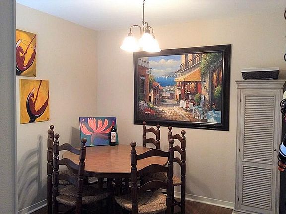 Dining room with updated wood laminate flooring that opens to living room.