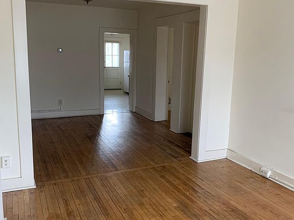 View from living room into dining room, kitchen in far room.