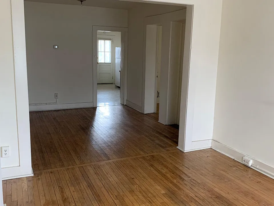 View from living room into dining room, kitchen in far room.