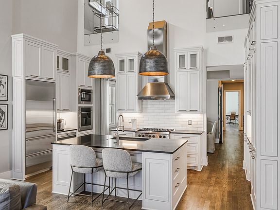 The chef's kitchen boasts a massive island, pantry wall, Wolf steam & convection ovens, a 6-burner 36" gas range and Sub-Zero refrigerator. Everything you need to cook at home, plus island seating and a dining table/room.