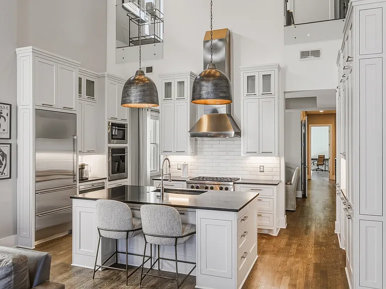 The chef's kitchen boasts a massive island, pantry wall, Wolf steam & convection ovens, a 6-burner 36" gas range and Sub-Zero refrigerator. Everything you need to cook at home, plus island seating and a dining table/room.