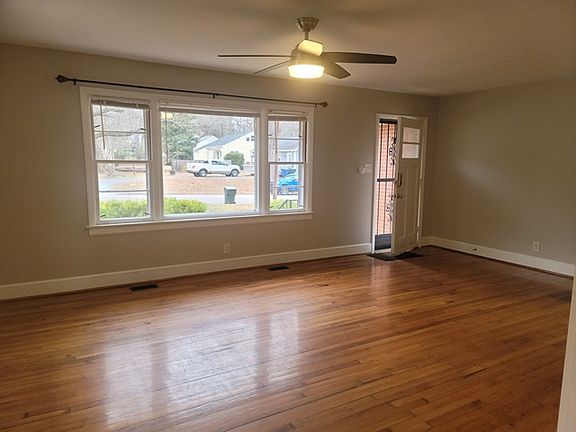 Enter the generously size 14 x 20 LIVING ROOM with its hardwood floors, large picture windows + ceiling fan.