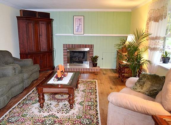 Gas fireplace with brick surround anchors the room