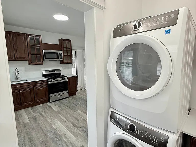 Laundry room off kitchen with full size appliances.
