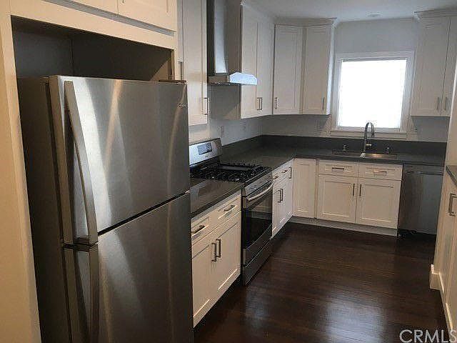 Renovated fully equipped kitchen with refrigerator, gas stove and oven, microwave and dishwasher