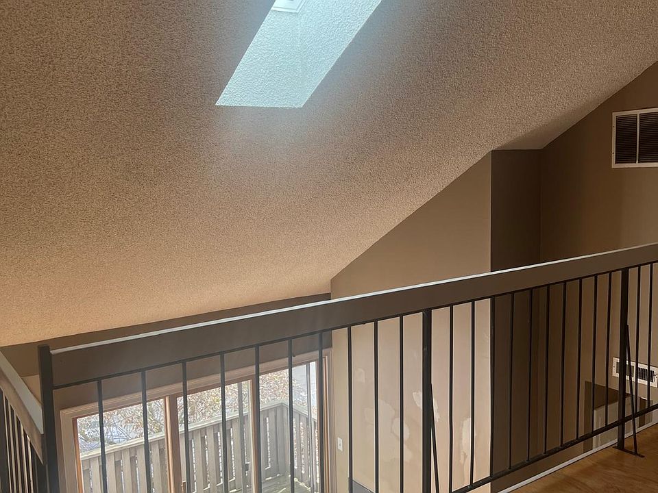 Loft with skylight overlooking living area.