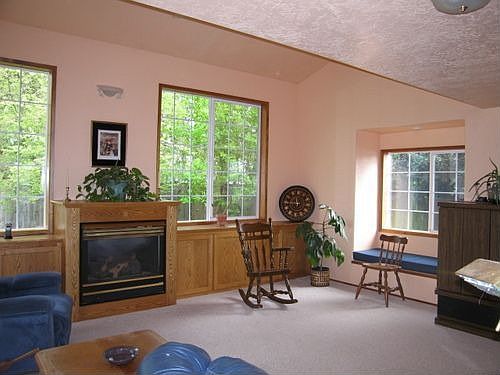 Large den with fireplace and built in cabinets