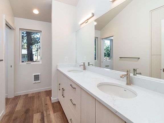 Bathroom (outside pocket door). Double sink; stacked washer and dryer at the end of the sinks (behind wall).