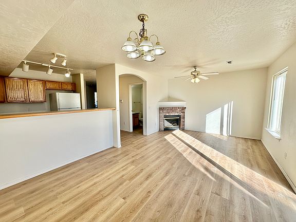 Living and dining area with electric fireplace and new luxury vinyl flooring.