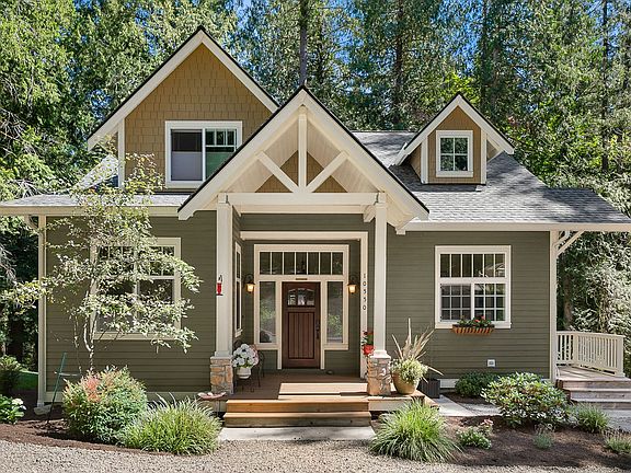 Beautiful NW Craftsman style home built in 2016 with stunning curb appeal in a private park like setting.