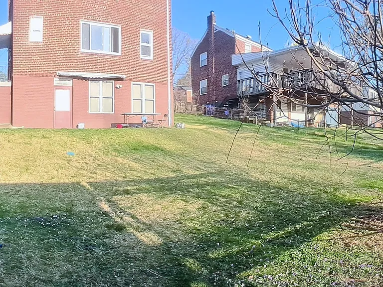 Shared use of large backyard. Private entrance to unit is visible in this photo. The unit looks out onto a patio and the yard.