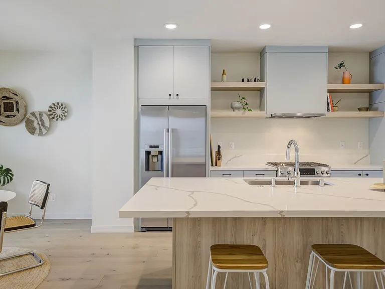 Second-floor kitchen and dining area featuring a large center island, perfect for cooking, gathering, and entertaining.