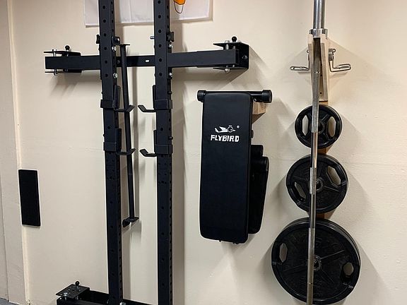 Garage workout bench & squat rack available. Folds in to still allow car to fit.