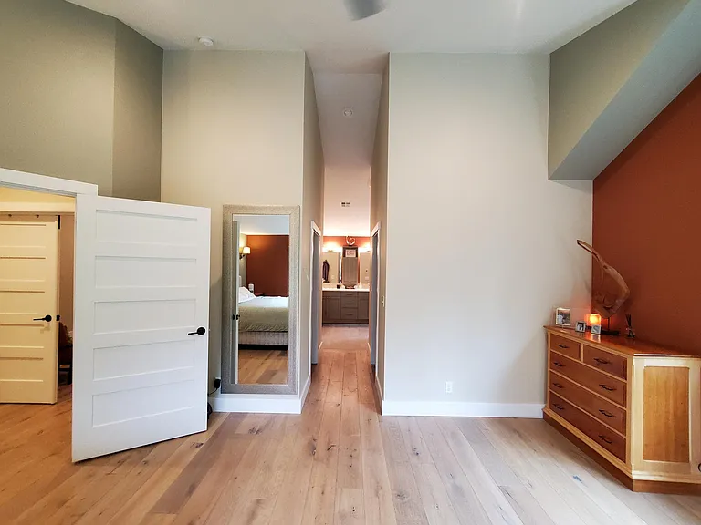 Primary bedroom has an open hallway to 2 walk in closets and the primary bathroom.