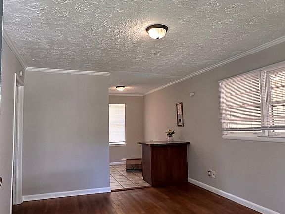 Living room with bar area connecting to the kitchen and dinning room