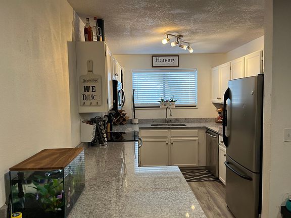 Granite counter tops and stainless steel appliances.