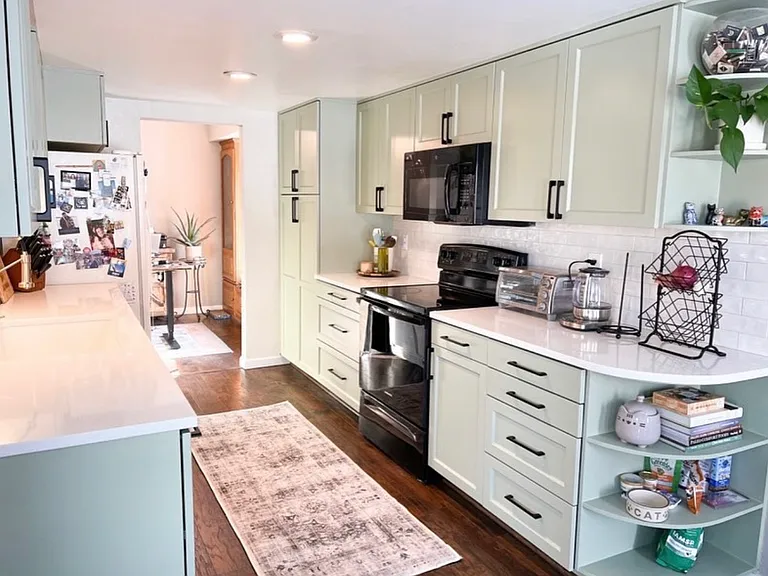 Newly updated kitchen with quartz countertops, custom shelving, and large pantry.