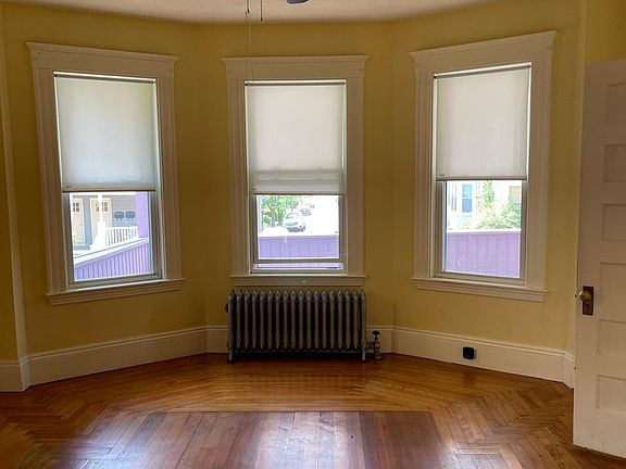 Front living room with bow window looking out to porch.