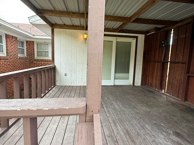 The covered deck looking towards the sliding glass door to the 3rd living area.