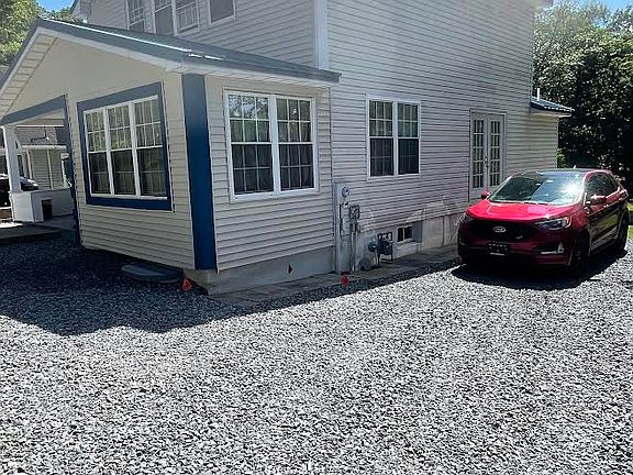 Right side of home with parking area