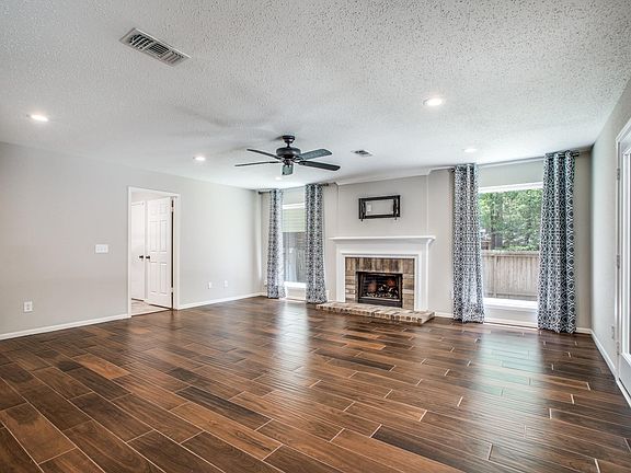 The family room, grounded by a gas log fireplace, is full of bright natural light!