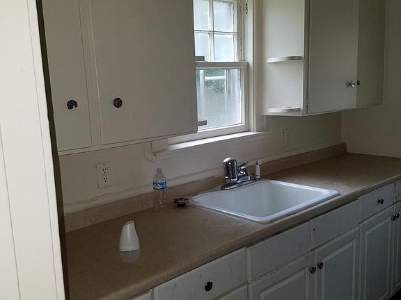 Older picture new stainless steel sink and faucet added with gray counter top. Also fresh paint in kitchen
