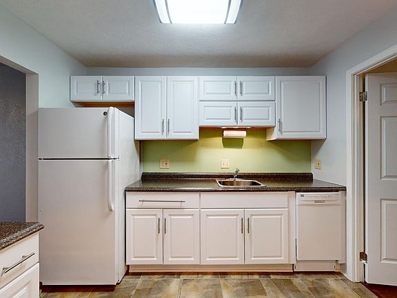 Large eat in Kitchen featuring pull out pot/pan drawers, dishwasher, disposal, under cabinet lighting, large fridge, microwave & range