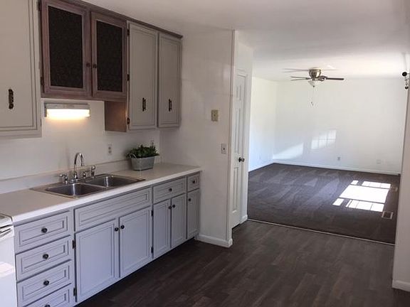 Equiped Kitchen with stove, refrigerator, and waste disposal.