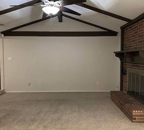 Living room has wood-burning fireplace.