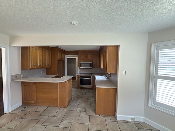 Kitchen area with microwave, oven and Bosch dishwasher.