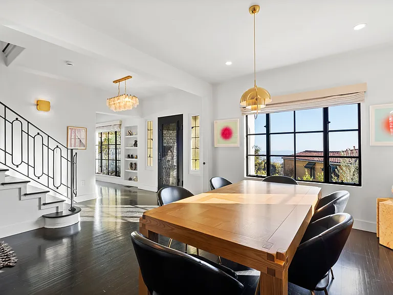 Dine in style with designer pendant lights and expansive outdoor views.