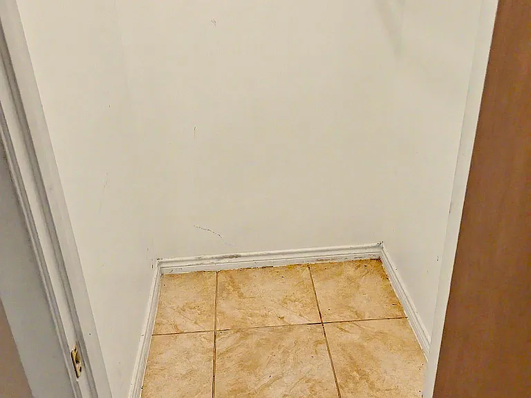 Dedicated closet area with a hanging rod and shelf, offering convenient storage and easy access off the main room.