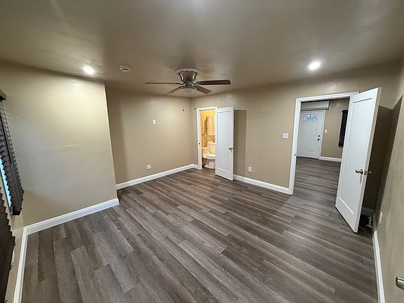 Master bedroom with bathroom that leads to hallway.
