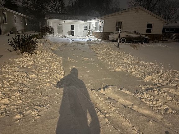 Unfortunately snowy but long driveway. Driveway has a portion off to the right that connects and is an additional paved parking spot where the car is pictured