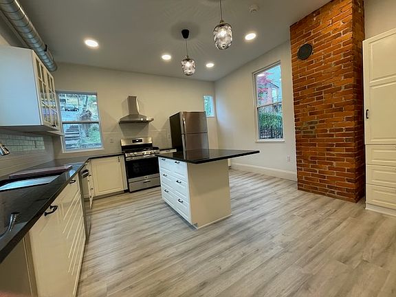 Kitchen with granit top island and stainless appliances