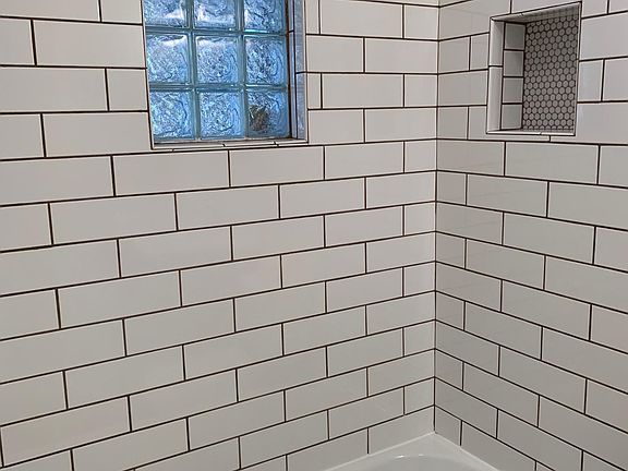 Designer tile bathtub