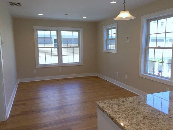 View of living room 2nd story corner unit F which gets a lot of light!
