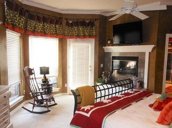 Roomy master bedroom with fireplace, sitting area, door to backyard