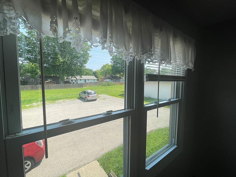 Large Windows overlooking green space with parking