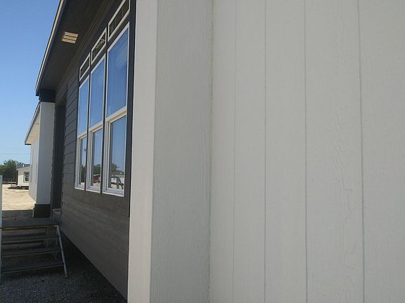 The home has lap siding as well with 12 inch eves and thermal windows .  Home is Crisp in appearance.