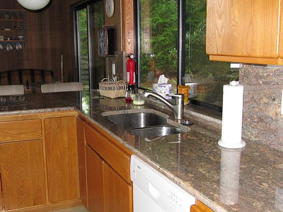 Kitchen features slab granite countertops and back-splash. Lots of cabinet space and is very "work f