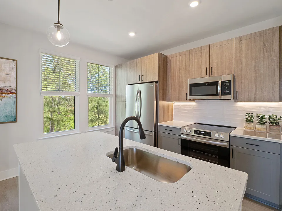 Elegant finishes including luxury vinyl plank flooring, contemporary kitchens, tile backsplash, stainless steel appliances and Quartz countertops